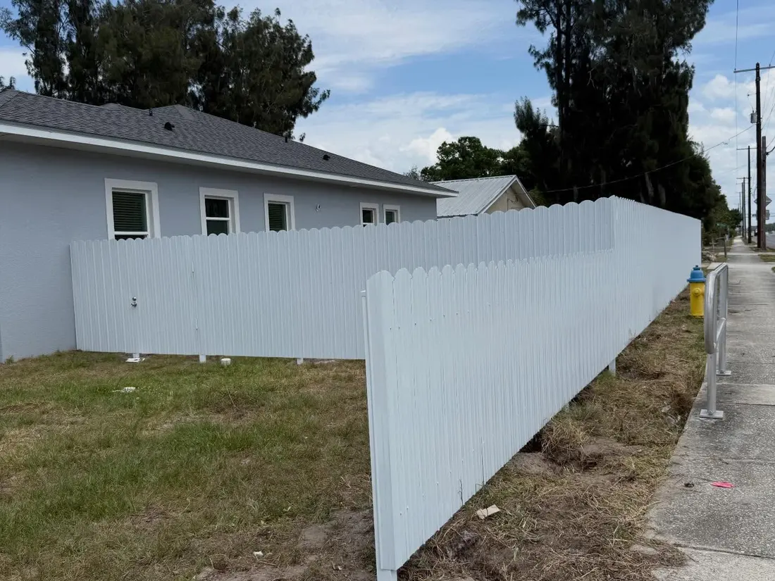 White vinyl fence along a corner lot sidewalk