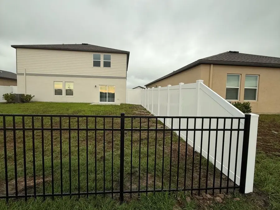 Fence company Cocoa Beach, FL β black aluminum fence and white vinyl privacy fence at a new-construction home