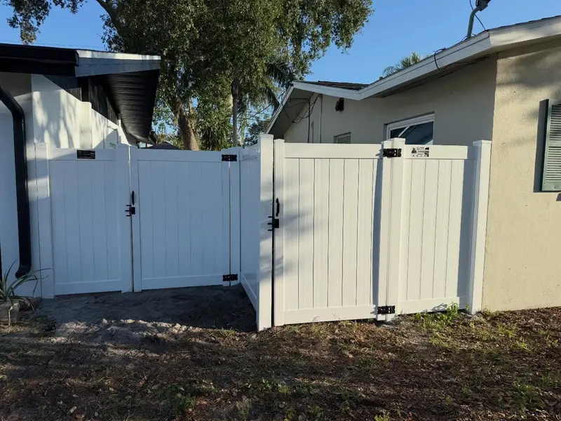 New white vinyl double gate installed on a Tampa property