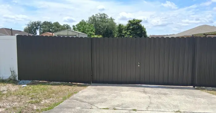 Dark privacy fence installation around a Tampa home