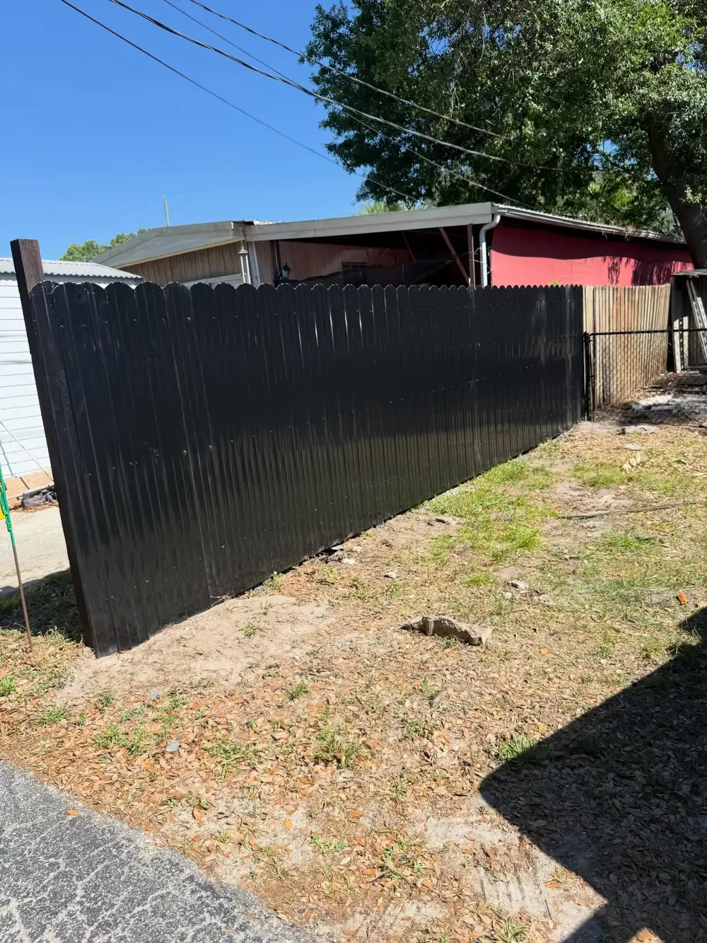 Newly installed privacy fence with gate in a Tampa, FL yard