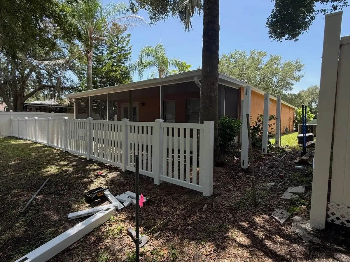 Daimon Fence work truck and trailer on a Tampa, FL job site